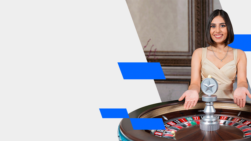 A smiling woman standing beside a roulette table with a trophy-like object on top. She is gesturing with open hands, wearing a sleeveless beige dress. Blue geometric shapes accent the white and gray background.