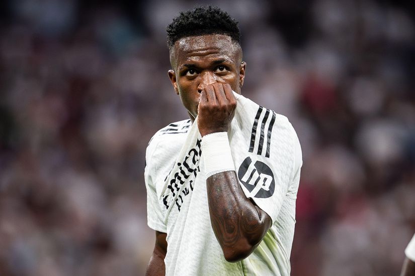 A soccer player in a white jersey lifts his shirt to his face, standing out in sharp focus against the blurred stadium backdrop. Sponsored by Betway Arabia, he embodies the spirit of the game and captures the essence of passion on and off the field.