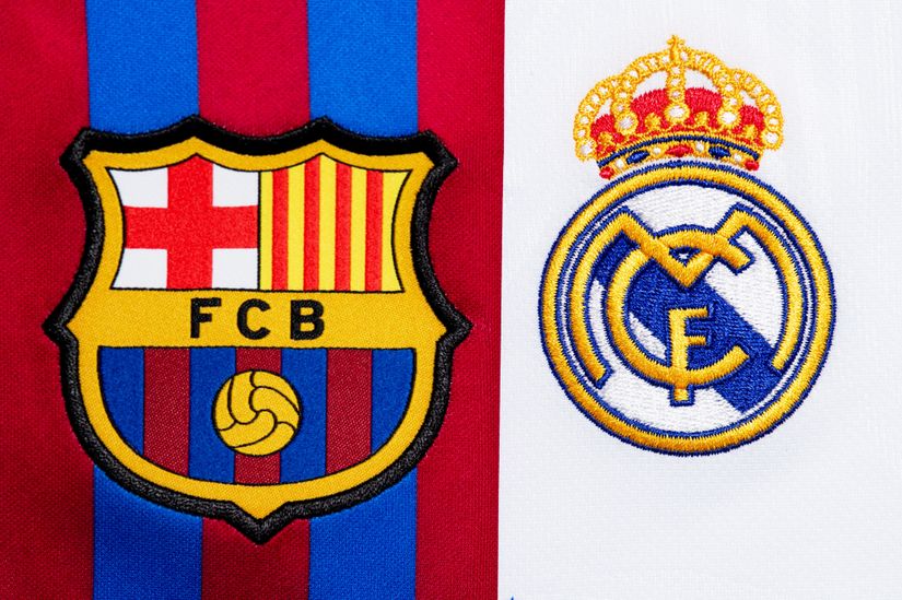 FC Barcelona’s crest on a red and blue background next to Real Madrid’s crest on a white background.