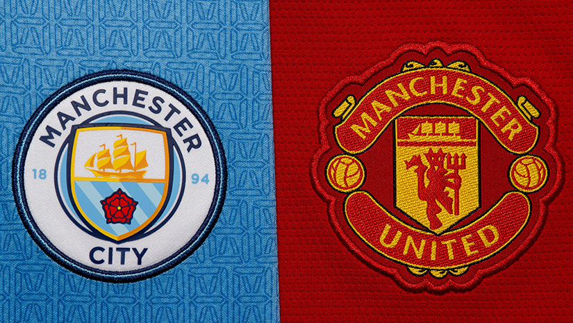 Manchester City and Manchester United logos stand side by side in a compelling display. The City logo, with its ship and rose on blue, and the United logo featuring a red devil and ship on red, are both elaborately embroidered—a sight worthy of a Betway Arabia fans admiration.